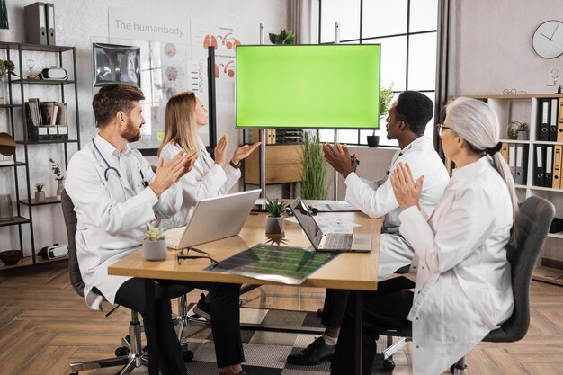 A close-up image of researchers presenting their work at a biotech conference, focusing on the interactive nature of the presentation and the engagement of the audience.