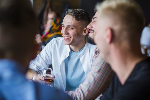 A candid shot of attendees at a US Biotech Event's networking mixer, laughing and engaging in lively conversations over drinks and appetizers.