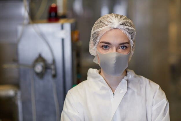 A medium shot of a female intern in a cleanroom suit, working with a laminar flow hood. She is focused on a petri dish, and the sterile environment is highlighted by the soft, diffused lighting.