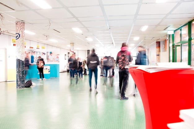 A wide shot of a career fair, with students lined up at booths of biotechnology companies. Company banners are visible, and recruiters are engaging with students, answering questions and collecting resumes.