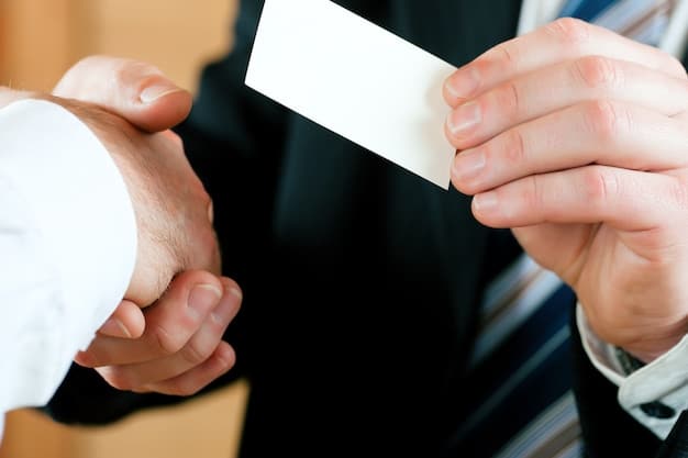 A close-up of business cards being exchanged between two biotech professionals during a networking break at a conference. The cards have company logos and contact information.