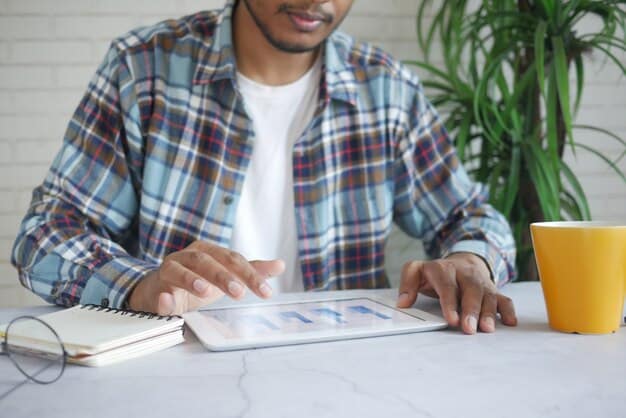 A person is seen comparing interest rates and loan terms on a tablet, with charts displaying potential savings from refinancing student loans. The setting is a bright, modern office, symbolizing financial empowerment.