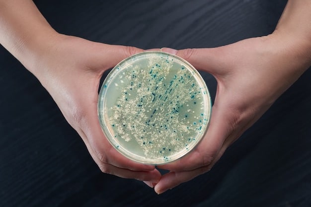 A close-up of a hand holding a Petri dish with glowing cultures, symbolizing biotech research. The background is blurred, emphasizing the innovation and scientific discovery inherent in biotech startups.